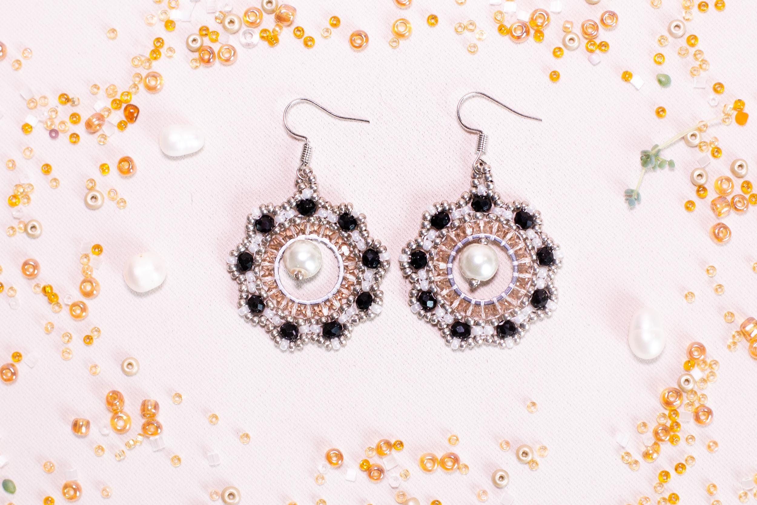 a pair of earrings sitting on top of a table